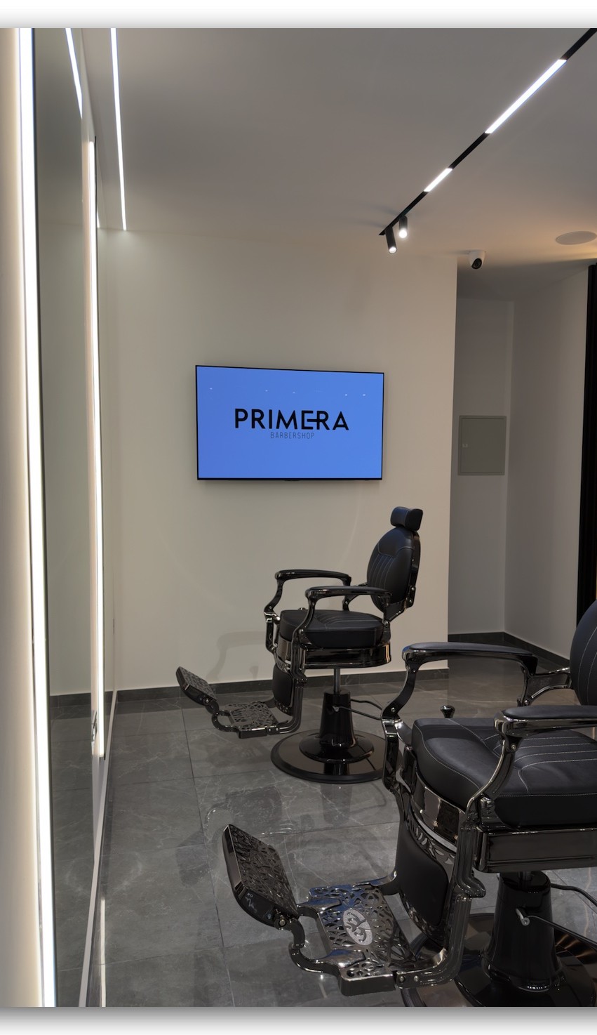 Barber chairs and the Primera screen inside the shop